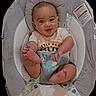 baby, baby_seat, child, clothing, cushion, cute, face, feet, happy, indoor, infant, infant_toys, patterned_fabric, person, plush, portrait, seat, smiling, toddler, young_child