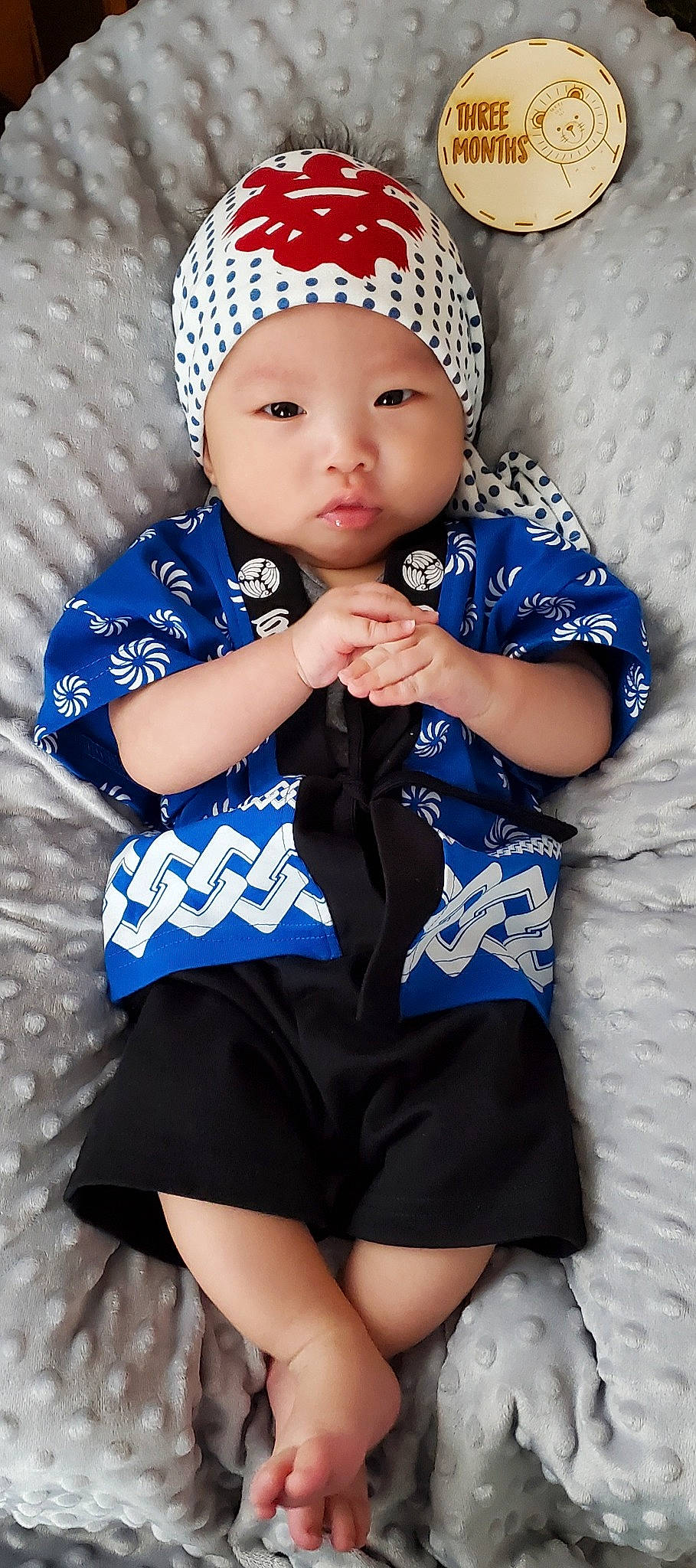 Kian is registered to the contest to win money with this photo: azure, baby, baby_toddler_clothing, black, blue, cap, clothing, eye, face, flash_photography, gesture, hand, headgear, headwear, neck, outerwear, person, photograph, sleeve, textile