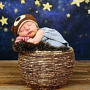 Myles joined the competition — help win amazing prizes! baby, basket, bear_hat, blue_background, child, cozy, cute, fur, hat, infant, knitted, newborn, peaceful, portrait, props, resting, sleeping, starry_background, stars, wooden_floor