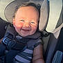 baby, child, car_seat, smiling, happy, blue_eyes, sunlight, seat_belt, infant, cute, portrait, safety_harness, closeup, young_child, indoor, striped_clothing, chubby_cheeks, headrest, person, seat