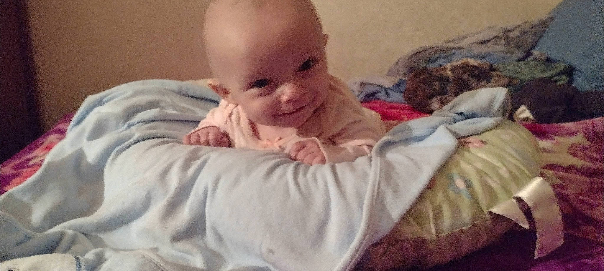 Abigail is registered to the contest to win money with this photo: baby, baby_toddler_clothing, cheek, child, comfort, eyebrow, fun, hairstyle, happy, head, iris, joy, linens, mouth, nose, person, sitting, skin, sleeve, smile