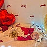 baby, infant, child, portrait, lying_down, smiling, birthday, six_months, red_clothing, headband, blanket, teddy_bear, balloons, fairy_lights, bows, indoor, celebration, cozy, photography, face