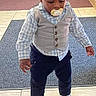 toddler, child, pacifier, vest, shirt, pants, shoes, flooring, tile, carpet, indoor, person, baby, hair, standing, looking_down, clothing, cute, small_child, casual
