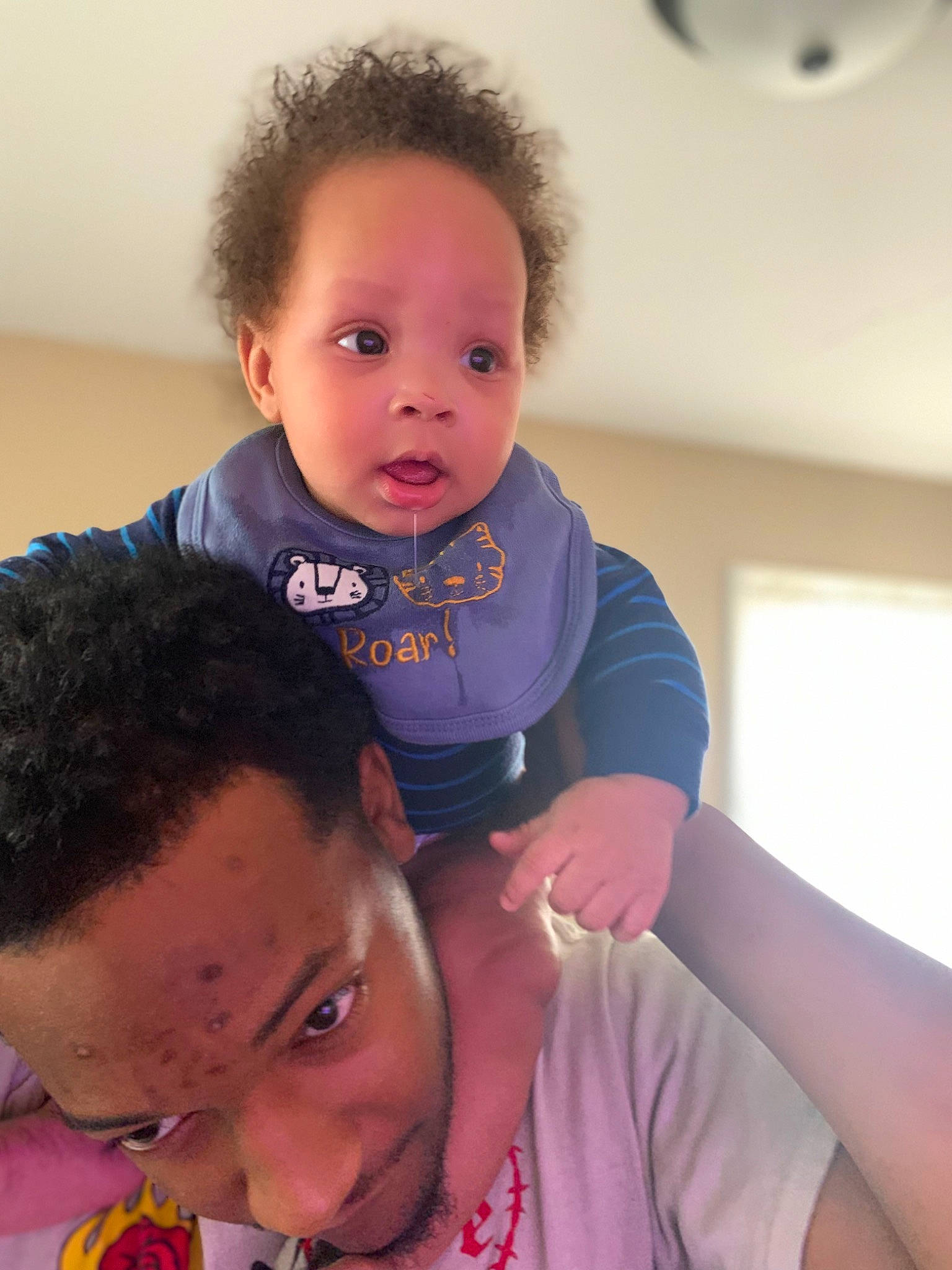 Alonzo is registered to the contest to win money with this photo: baby, baby_toddler_clothing, cheek, child, comfort, eyebrow, eyelash, fun, gesture, happy, iris, lip, mouth, neck, nose, organ, person, skin, surprise, t_shirt