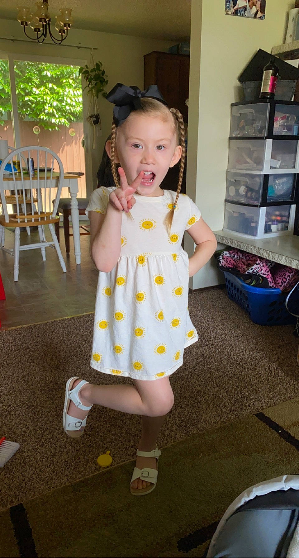 Zariyah joined the competition — help win amazing prizes! baby_toddler_clothing, child, day_dress, dress, flooring, fun, happy, human_leg, joint, knee, one_piece_garment, pattern, person, shelf, skin, sleeve, smile, snapshot, sock, standing