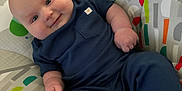 Lucious joined the competition — help win amazing prizes! baby, infant, smiling, blue_clothing, baby_seat, colorful_pattern, toucan, indoor, cute, chubby_cheeks, relaxing, child, person, portrait, happy, baby_toys, comfort, seat, foot, hand