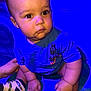 baby, child, infant, sitting, blue_light, curious, chubby_cheeks, short_hair, clothing, tshirt, socks, hand, footwear, indoor, blanket, portrait, cute, person, skin, face