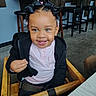 Mi'Chylah is registered to the contest to win money with this photo: toddler, child, smile, blue_eyes, hair_bows, high_chair, wooden_chair, black_jacket, pink_shirt, indoor, cafe, table, stool, contemporary, happy, person, cute, portrait, seated, young_child