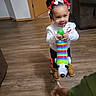 Mi'Chylah joined the competition — help win amazing prizes! toddler, child, toy, xylophone, dog_toy, hair_bows, boots, wooden_floor, couch, door, indoor, smile, play, person, clothing, room, hand, colorful, happy, young_child