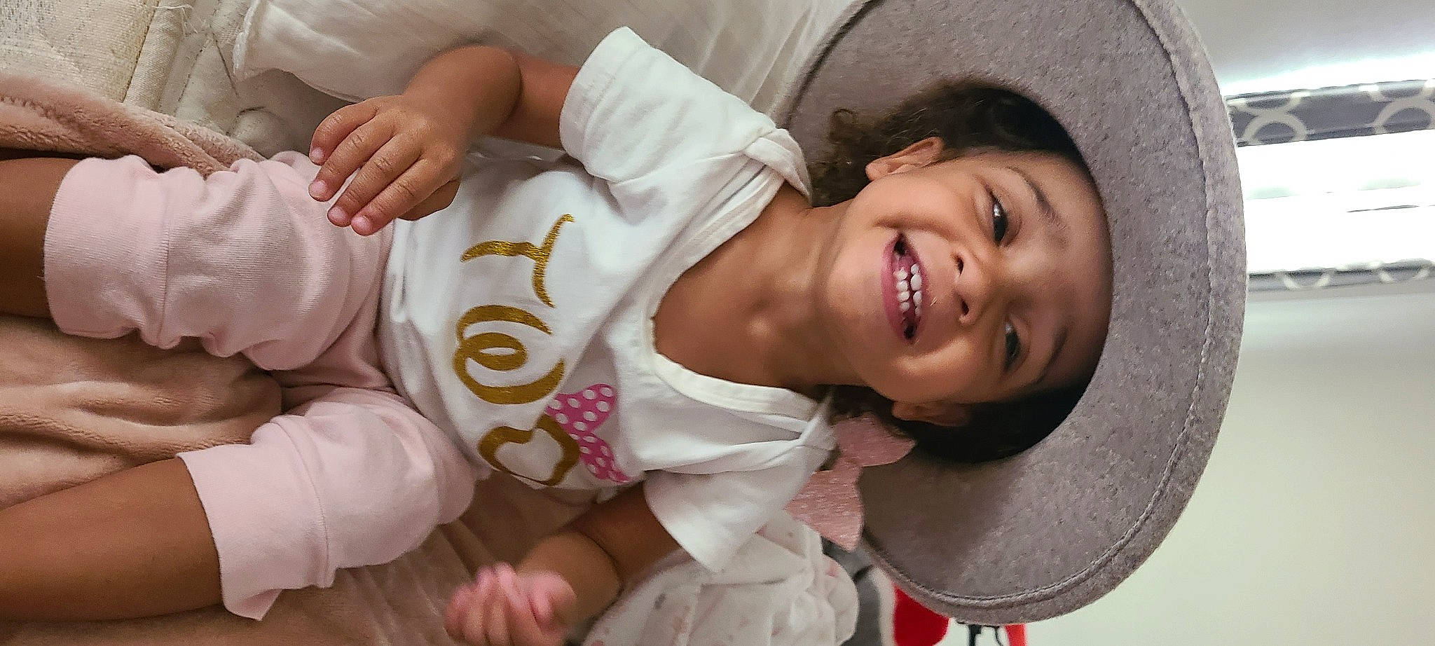 Emmy is registered to the contest to win money with this photo: arm, cheek, chin, clothing, eye, eyebrow, facial_expression, hand, happy, hat, human_body, joy, lip, mammal, mouth, neck, nose, person, product, skin