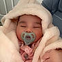 baby, pacifier, blanket, hood, sleeping, infant, pink_clothing, hand, cozy, soft_texture, indoor, child, cute, peaceful, person, portrait, warm, rest, comfort, nursery