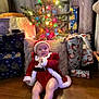Winter joined the competition — help win amazing prizes! baby, celebration, child, christmas_lights, christmas_tree, cute, decorations, festive, floor, gift_wrap, happy, holiday, indoor, person, pillow, presents, red_clothing, santa_outfit, seasonal, smiling