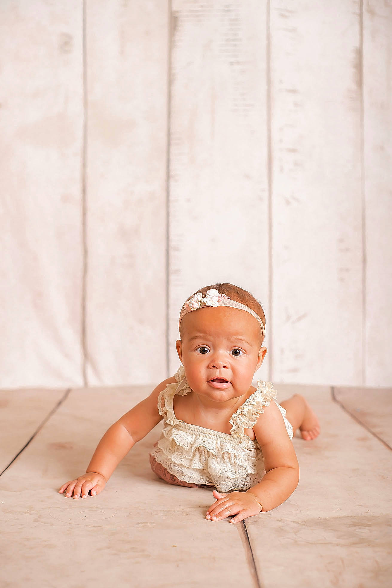 Kailani joined the competition — help win amazing prizes! baby, baby_toddler_clothing, child, embellishment, fashion_accessory, floor, flooring, foot, hair_accessory, happy, hardwood, headband, headgear, headpiece, pattern, peach, person, sitting, sleeve, toddler