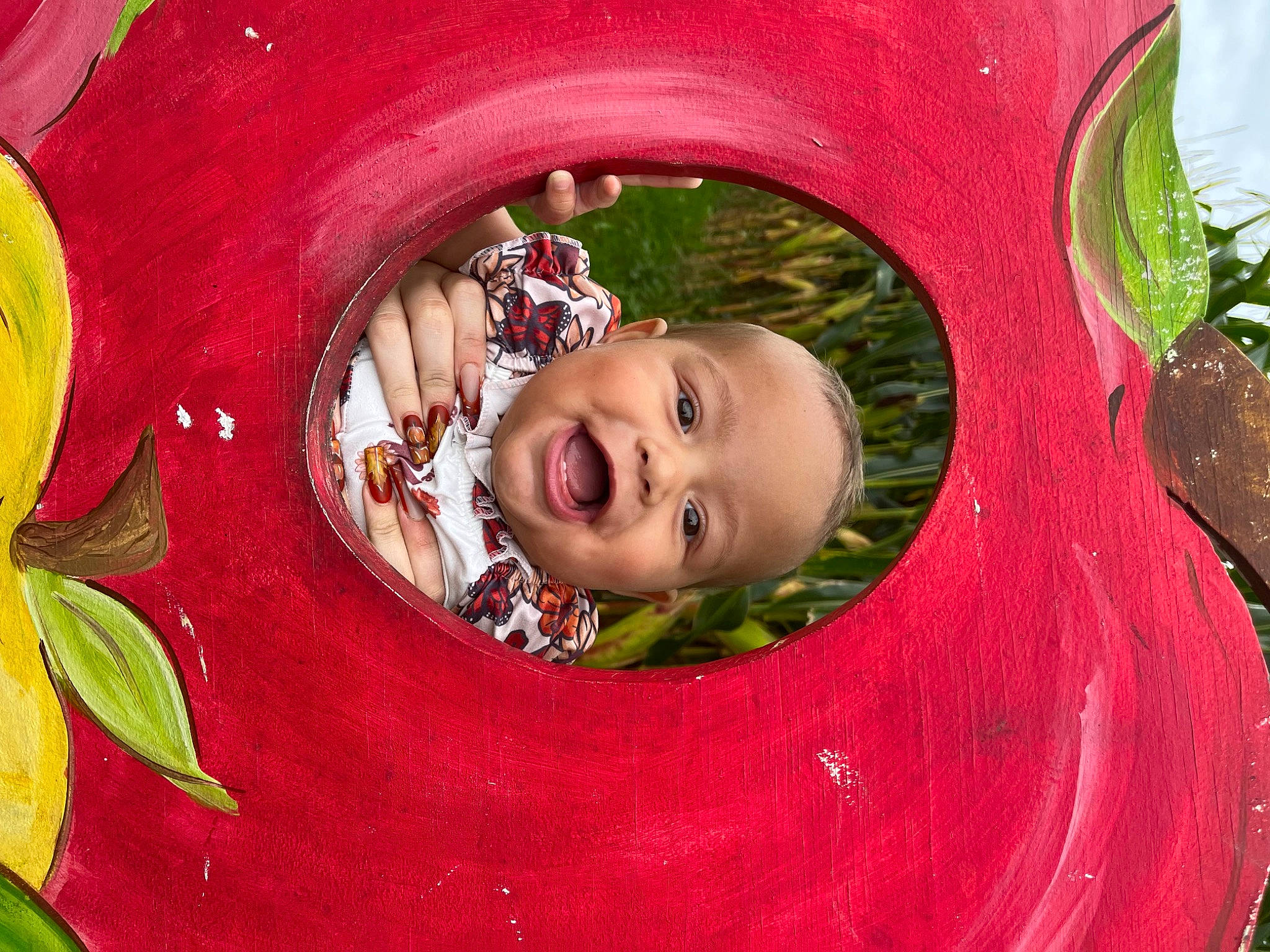 Kailani joined the competition — help win amazing prizes! art, baby, baby_toddler_clothing, botany, cheek, fun, grass, happy, headgear, human_body, iris, leaf, magenta, paint, people_in_nature, person, pink, plant, smile, toddler