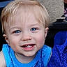 child, toddler, blue_eyes, blonde_hair, smiling, face, portrait, sleeveless_shirt, blue_clothing, close_up, person, cute, happy, outdoor, fabric, texture, background, human, skin, young