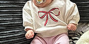 Mekltiè-Lee joined the competition — help win amazing prizes! baby, infant, pacifier, headband, pink_bow, white_sweater, pink_pants, socks, couch, blanket, texture, cozy, cute, child, portrait, indoors, clothing, soft, relaxed, smiling