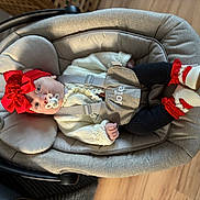 Mekltiè-Lee joined the competition — help win amazing prizes! baby, infant, pacifier, red_bow, headband, knitted_sweater, black_leggings, baby_carrier, joie_brand, footwear, baby_shoes, wooden_floor, indoor, child, cute, portrait, relaxed, cozy, padded, lying_down