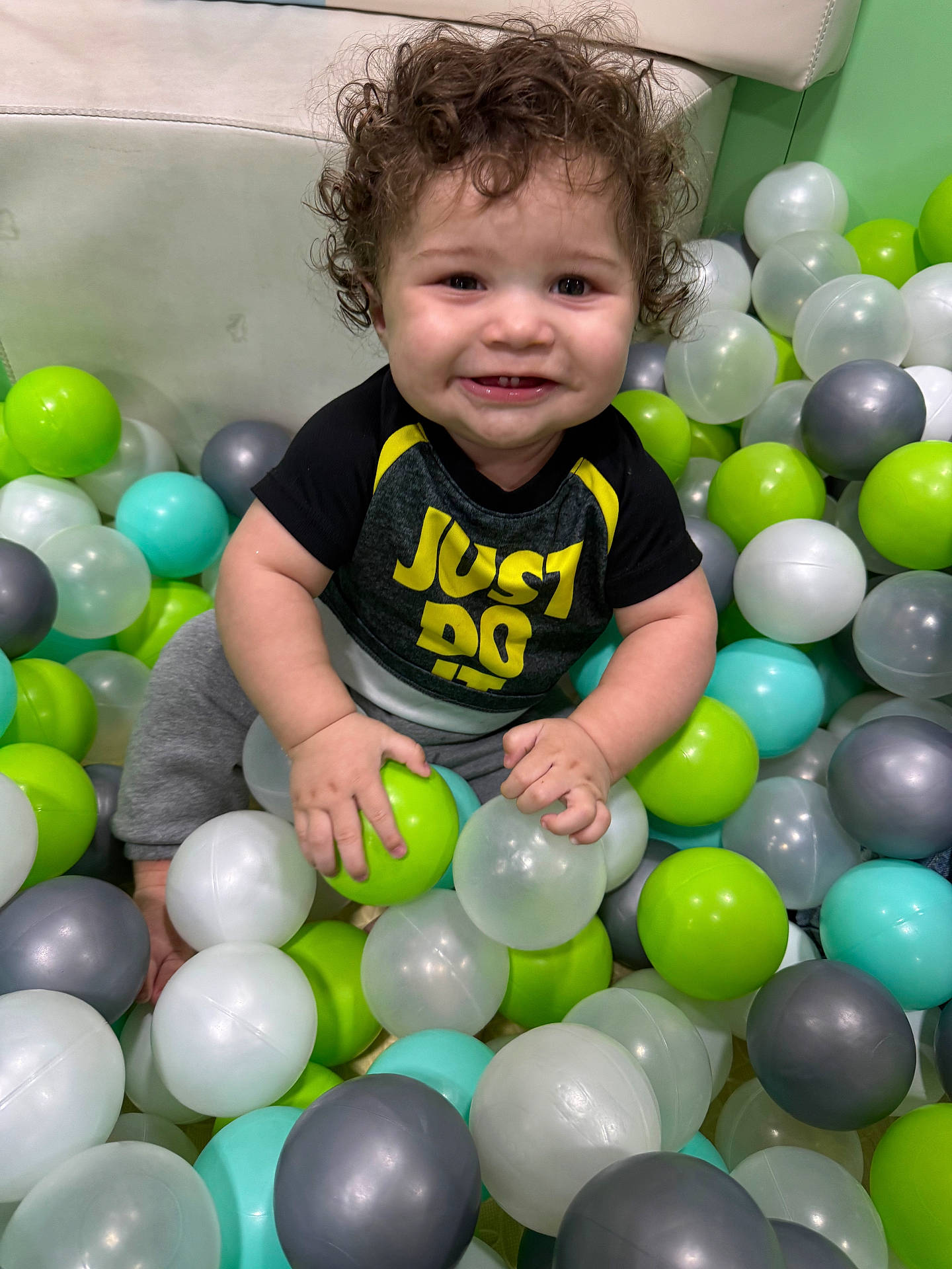 Zaidyn is registered to the contest to win money with this photo: accessories, baby, balloon, bodypart, clothing, face, finger, hand, happy, head, inflatable, people, person, photography, playarea, portrait, sitting, smile, sphere, t_shirt