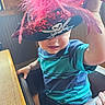 baby, child, costume, face, feathers, hand, high_chair, indoor, pink, pirate_hat, playful, portrait, selfie, sitting, skull, smiling, striped_shirt, sunlight, table, toddler