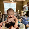 Hayes joined the competition — help win amazing prizes! baby, child, toddler, eating, cake, chocolate, messy, smiling, high_chair, dining_room, indoor, kitchen, family, hands, portrait, food, dessert, table, chairs, home