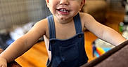 Hayes joined the competition — help win amazing prizes! arms, baby, blond_hair, blue_eyes, child, denim, face, furniture, happy, home, indoors, living_room, natural_light, overalls, photography, portrait, smiling, standing, table, toddler