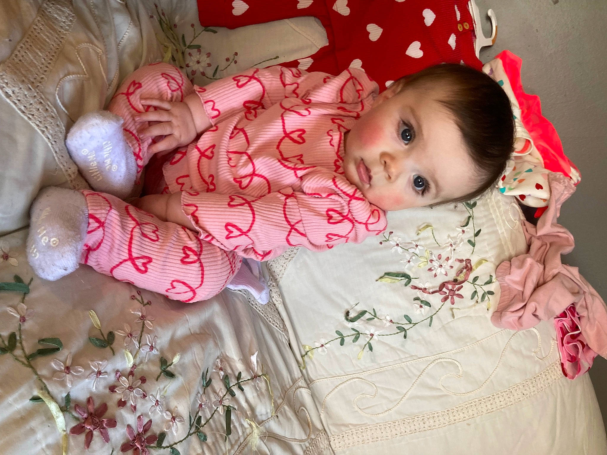 Kylie is registered to the contest to win money with this photo: baby, baby_toddler_clothing, cheek, child, comfort, happy, linens, magenta, nightwear, pattern, peach, person, petal, pink, portrait_photography, room, skin, sleeve, textile, toddler