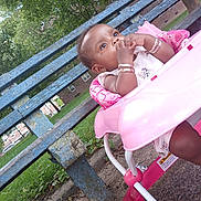 Faith is registered to the contest to win money with this photo: baby, child, walker, pink, outdoor, park, bench, greenery, curious, thoughtful, bracelet, grass, trees, sidewalk, building, daytime, person, infant, seat, playtime