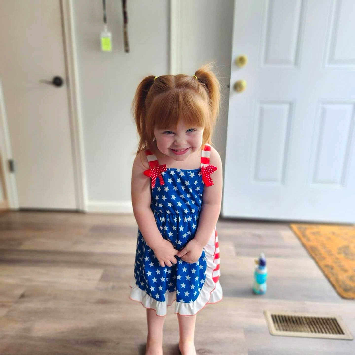 Hazel is registered to the contest to win money with this photo: child, clothing, costume, door, dress, face, female, footwear, girl, head, jeans, mat, pants, person, photography, plant, portrait, sandal, shorts, skirt