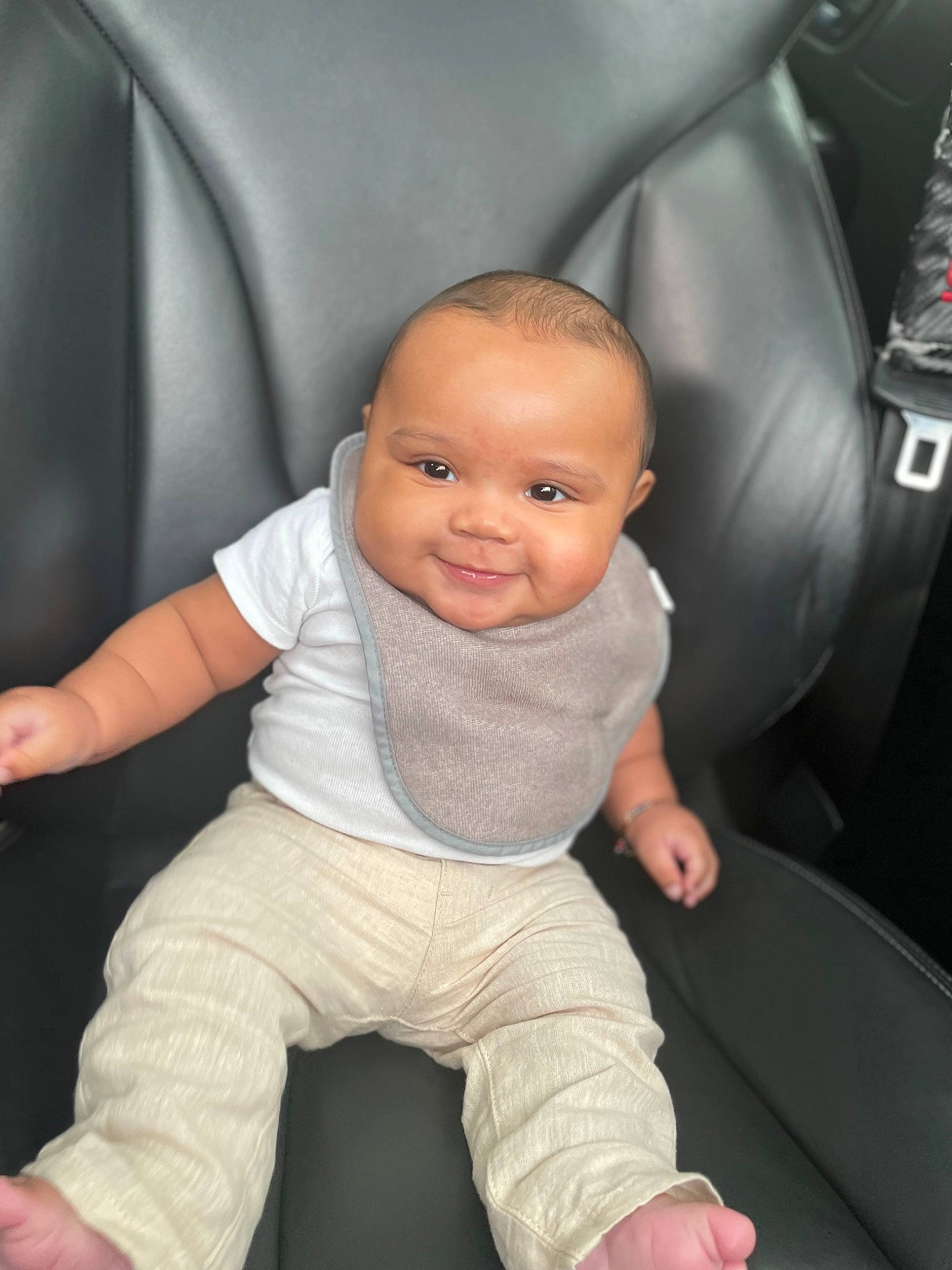 Allen is registered to the contest to win money with this photo: arm, automotive_design, baby, baby_toddler_clothing, car_seat, car_seat_cover, cheek, child, chin, comfort, eye, finger, flash_photography, fun, head, joy, person, skin, sleeve, smile