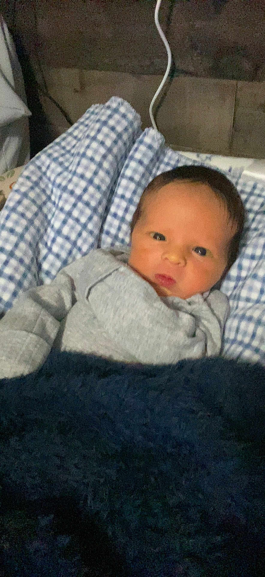 Paxton joined the competition — help win amazing prizes! baby, infant, blanket, blue, checkered, clothing, face, person, portrait, indoors, newborn, cute, sleeping_area, resting, cozy, soft, young_child, head, expression, warm