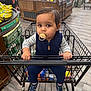 baby, toddler, child, pacifier, shopping_cart, supermarket, bananas, organic_section, navy_vest, striped_shirt, shoes, hands, face, eyes, sitting, grocery_shopping, aisle, wood_floor, groceries, portrait