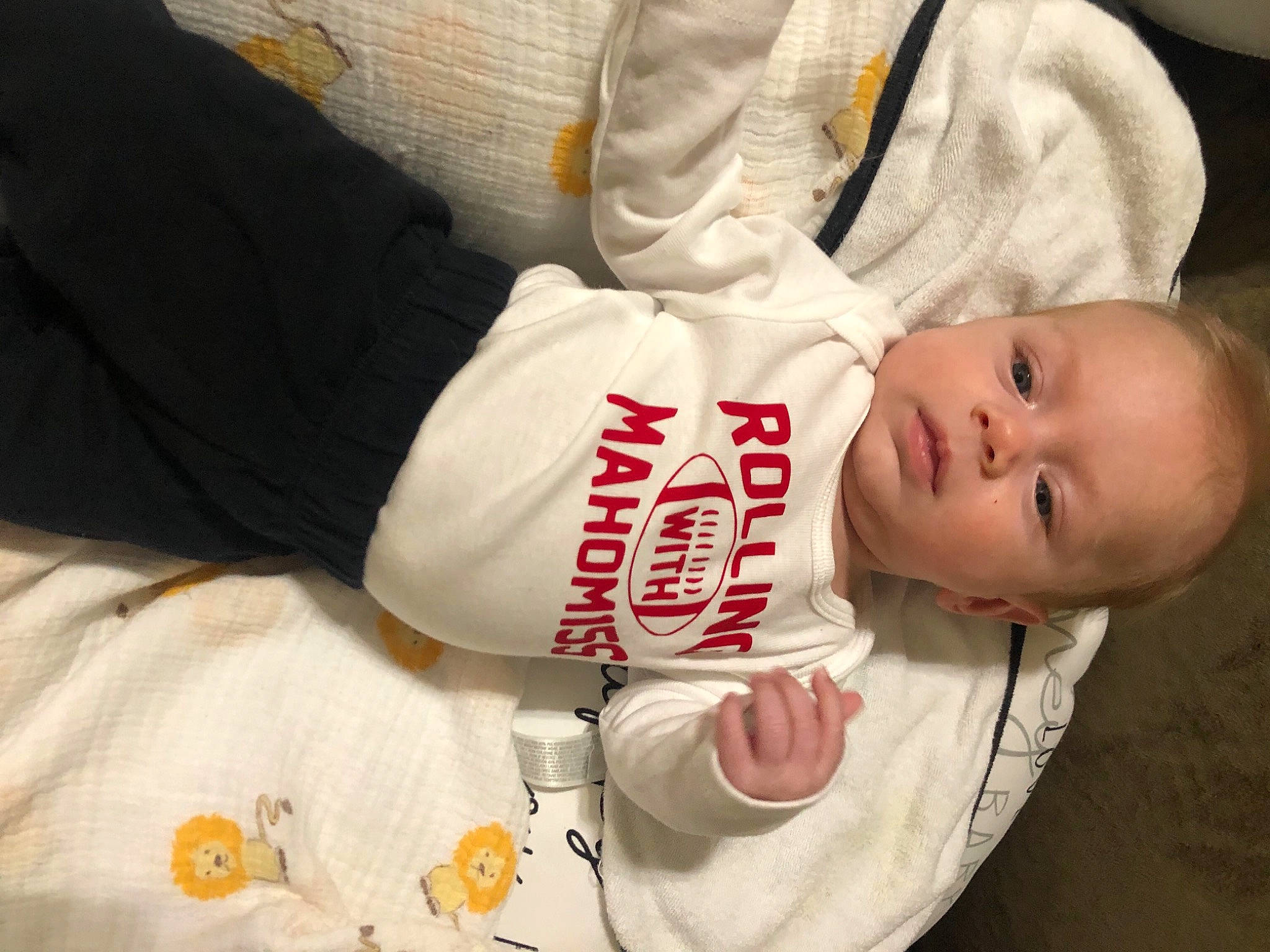 Fynn is registered to the contest to win money with this photo: baby, baby_products, baby_safety, baby_toddler_clothing, carmine, cheek, child, comfort, elbow, finger, hand, happy, hat, human_body, person, sitting, sleeve, t_shirt, toddler, white