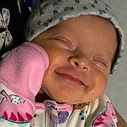 Nova is registered to the contest to win money with this photo: baby, child, closeup, colorful, cozy, cute, expression, face, hand, hat, infant, mitten, newborn, onesie, pattern, portrait, sleeping, smiling, soft, warm