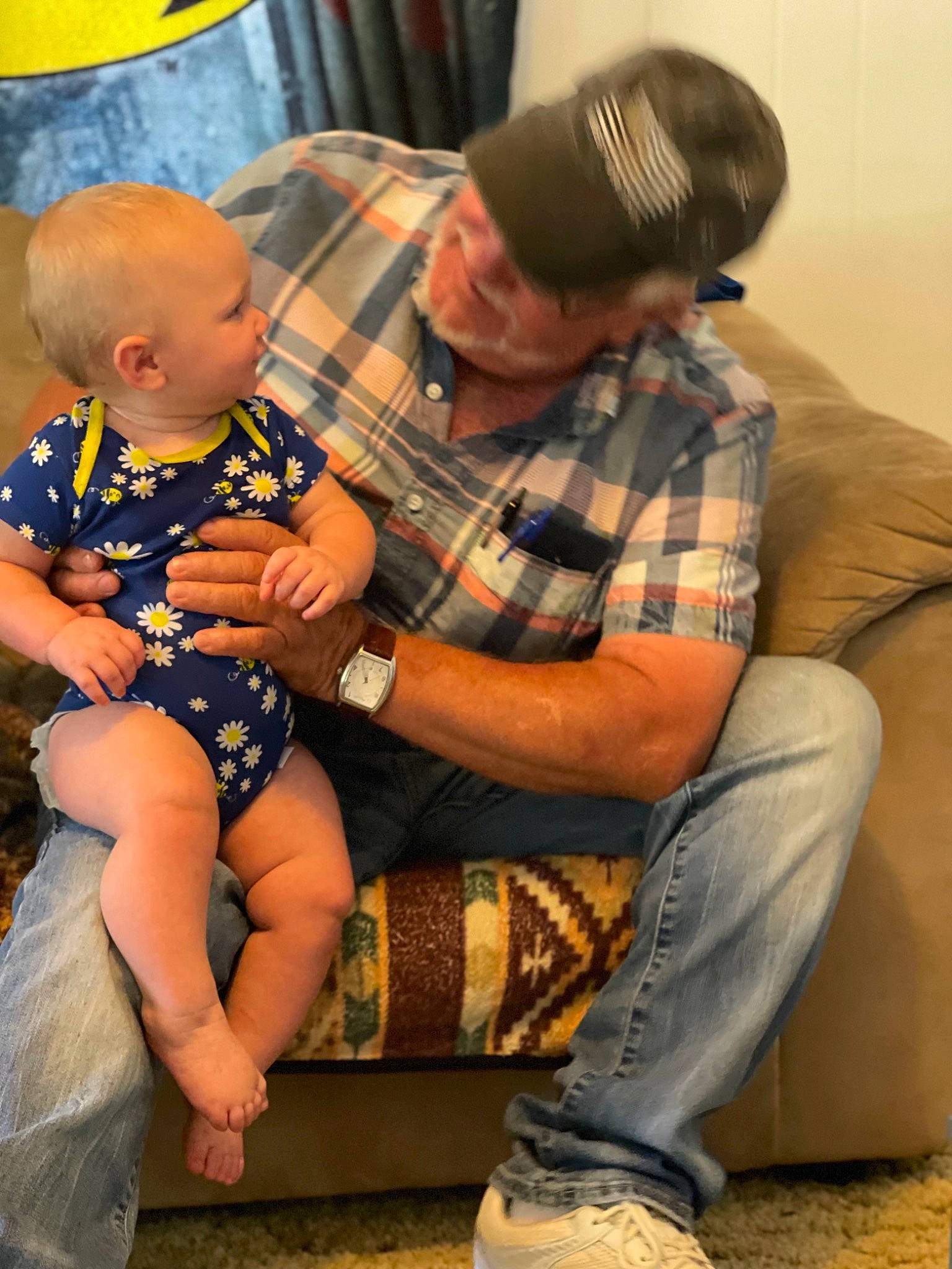 Jaelyn is registered to the contest to win money with this photo: baby, black, cap, child, comfort, event, fun, human_leg, lap, leg, pattern, people, person, plaid, sitting, tartan, textile, thigh, toddler, watch