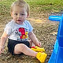 toddler, child, outdoor, birthday, shirt, shorts, yellow_shoes, grass, leaves, playground, blue_slide, sitting, hairstyle, curious, daylight, park, person, young_child, casual, ground