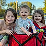 Coulson is registered to the contest to win money with this photo: child, children, smile, happy, wagon, outdoor, play, sunlight, casual_clothing, shorts, tshirt, hair, face, skin, daylight, nature, fun, park, family, siblings