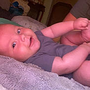 Layton joined the competition — help win amazing prizes! baby, infant, blanket, smile, face, arm, hand, furniture, bed, couch, clothing, person, indoor, home, soft, skin, curious, baby_girl, baby_boy, child