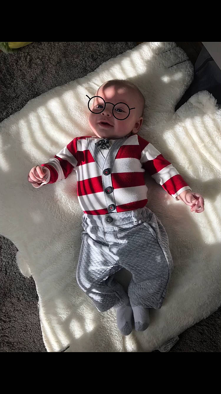 Cillian joined the competition — help win amazing prizes! baby_toddler_clothing, carmine, child, comfort, eyewear, fictional_character, fun, gesture, glasses, happy, linens, pattern, personal_protective_equipment, room, sleeve, smile, t_shirt, textile, toddler, vision_care