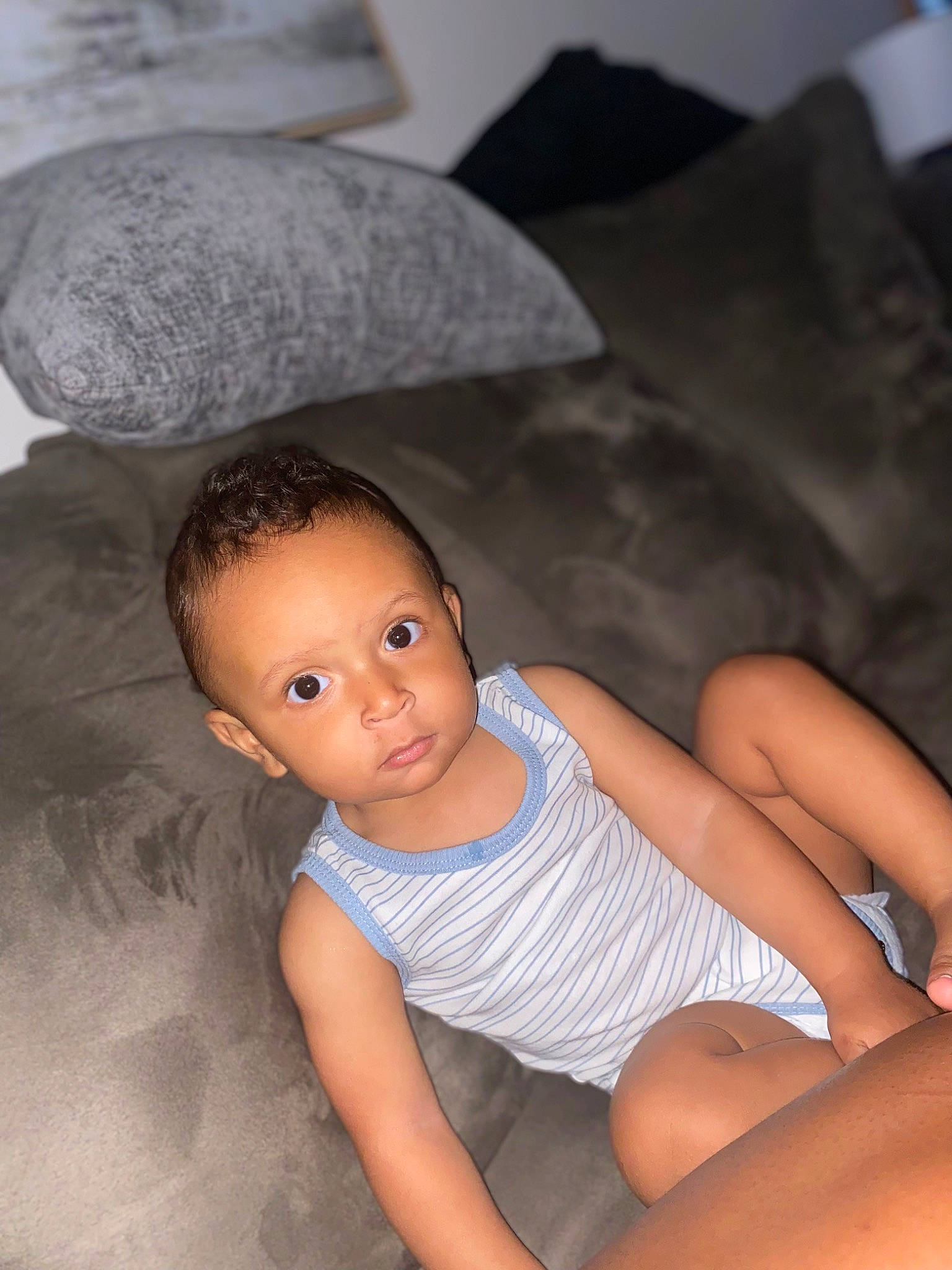Caiden is registered to the contest to win money with this photo: baby, baby_toddler_clothing, black_hair, child, comfort, elbow, face, facial_expression, finger, flash_photography, flooring, foot, gesture, human_leg, knee, mouth, person, skin, thigh, toddler