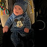 Zavier is registered to the contest to win money with this photo: baby, child, car_seat, blue_clothing, mickey_mouse, hat, smile, happy, infant, toy, plush, indoor, person, cute, warm_clothing, seat, childrens_toy, cozy, portrait, fuzzy
