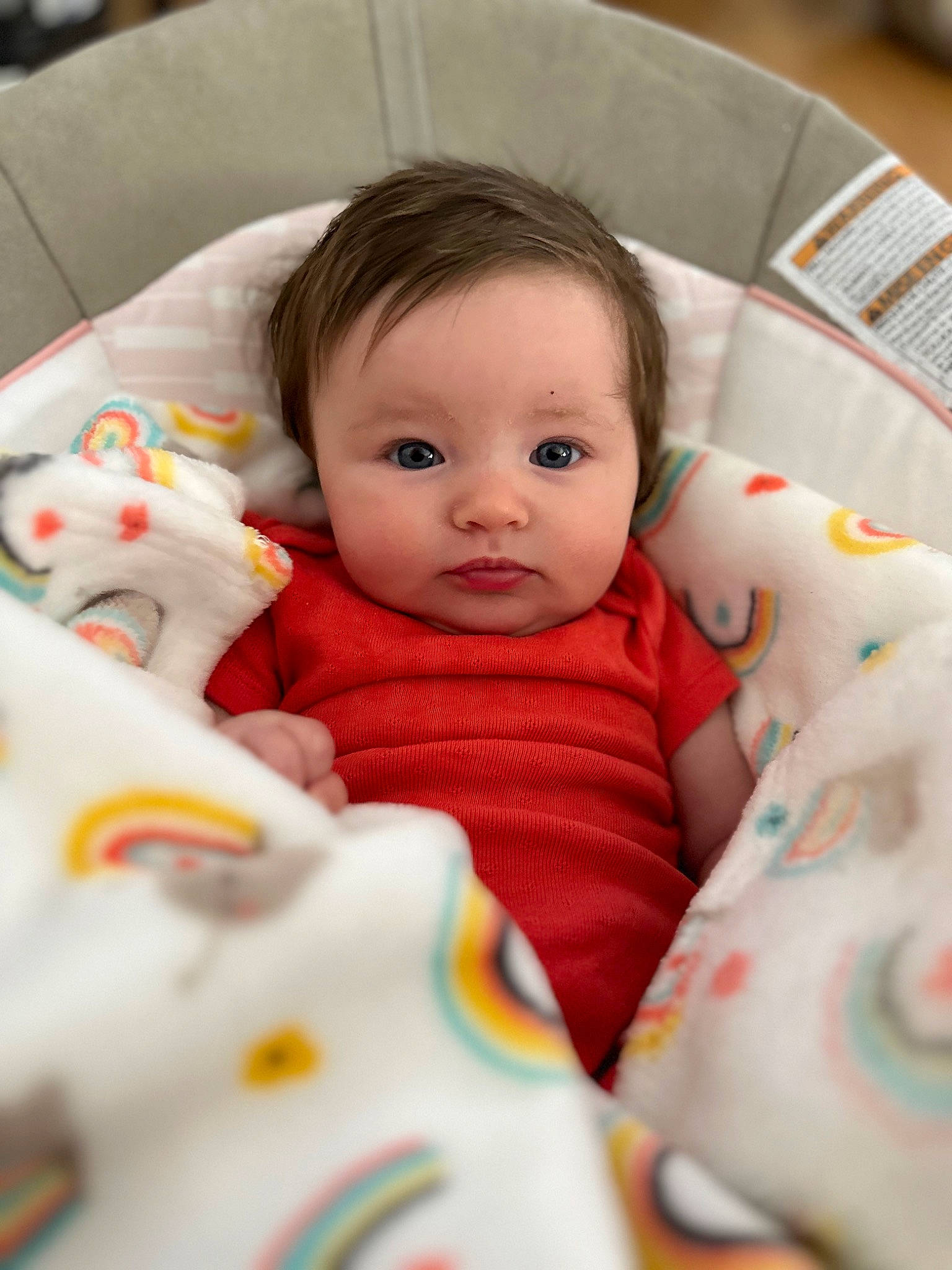 Peyton is registered to the contest to win money with this photo: baby, baby_products, baby_toddler_clothing, bedding, bedtime, cheek, child, comfort, face, happy, iris, linens, mammal, person, product, room, sitting, skin, sleeve, textile