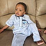 Sokowonchin is registered to the contest to win money with this photo: child, boy, couch, indoor, relaxed, clothing, light_blue, traditional_attire, car_patch, foot, hand, leather, furniture, portrait, casual, seated, young, expression, comfortable, home