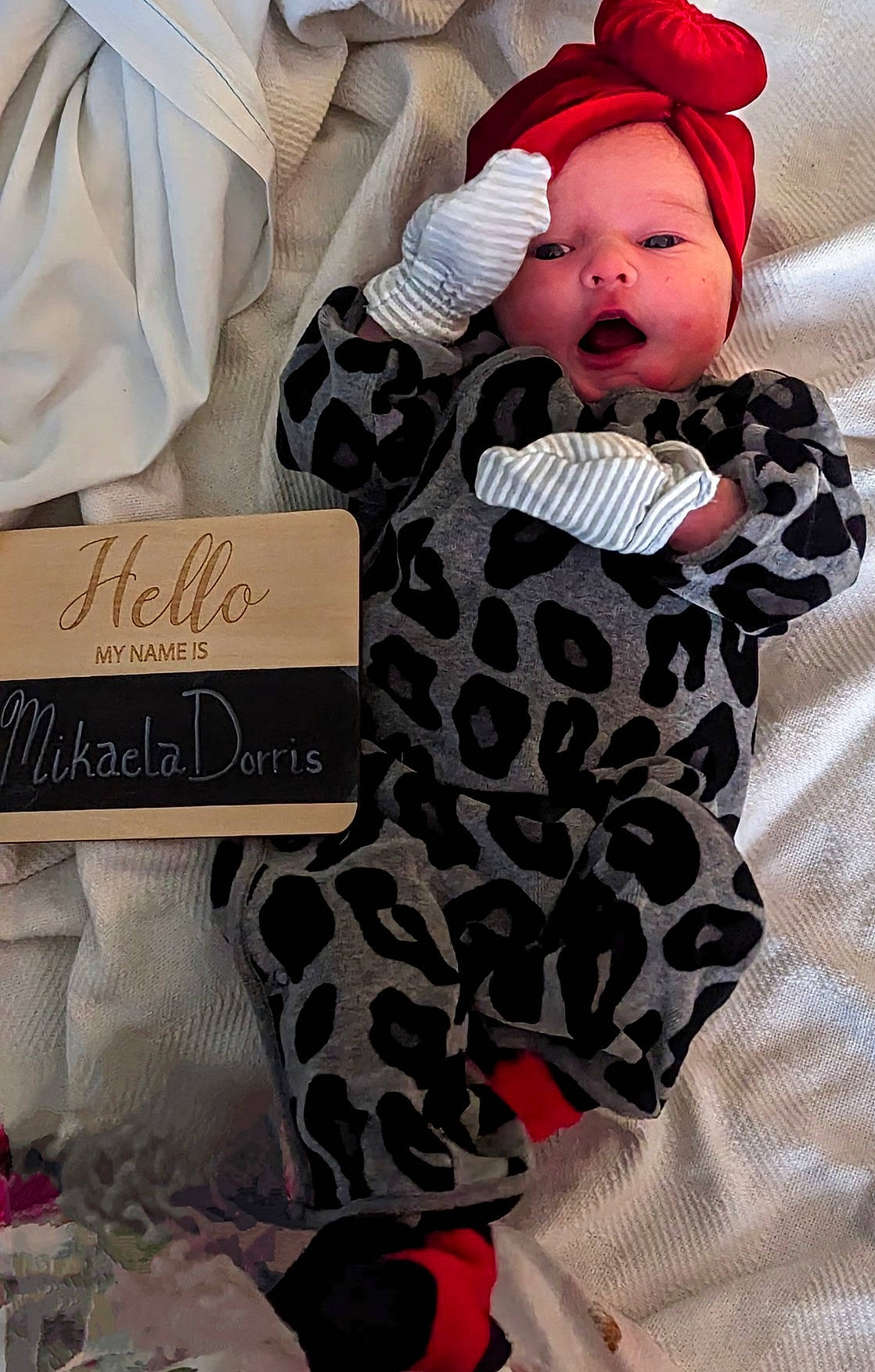 Mikaela is registered to the contest to win money with this photo: baby, baby_safety, baby_sleeping, baby_toddler_clothing, beanie, cap, carmine, child, comfort, face, font, linens, outerwear, pattern, person, room, sitting, sleeve, textile, toddler