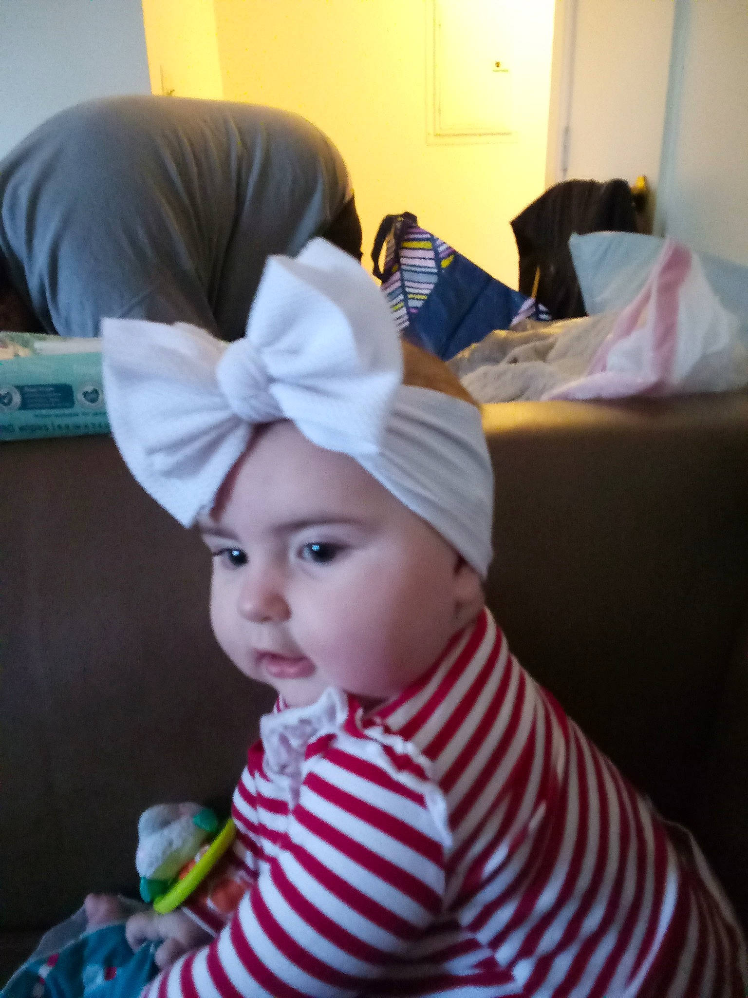 Raynah Gibson is registered to the contest to win money with this photo: baby, baby_toddler_clothing, beanie, box, cap, child, comfort, costume_hat, fashion_accessory, hat, headwear, linens, pattern, person, room, sitting, sleeve, textile, toddler