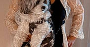 Willie Nelson joined the competition — help win amazing prizes! black_clothing, camouflage_outfit, casual, clock, curly_hair, decor, dog, expression, fluffy_dog, furniture, holding, home, indoor, lace_jacket, pet, portrait, rug, standing, tile_floor, woman