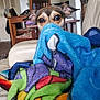 blanket, chair, colorful, comfort, cozy, curious, dog, ears, eyes, furniture, hiding, home, indoor, living_room, peeking, pet, relaxed, soft, table, wooden