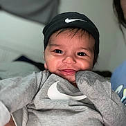Luca joined the competition — help win amazing prizes! toddler, child, smile, face, beanie, hat, nike_logo, sweatshirt, gray_clothing, indoor, portrait, cute, happy, person, baby, apparel, headwear, cozy, young_child, casual_wear
