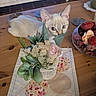 cat, flower, bouquet, table, wooden_table, potpourri, decor, leaf, pink_flower, green_leaf, domestic_cat, curious, indoor, pet, animal, houseplant, feline, closeup, cute, home