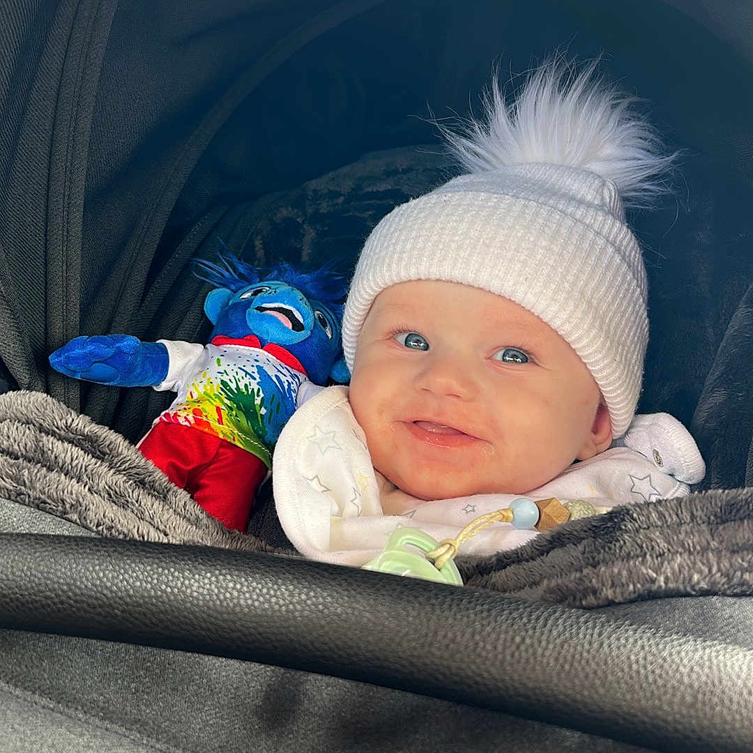 Carter is registered to the contest to win money with this photo: baby, beanie, bed, blanket, bonnet, cap, clothing, cushion, face, furniture, glove, happy, hat, head, homedecor, newborn, person, photography, portrait, sleeping