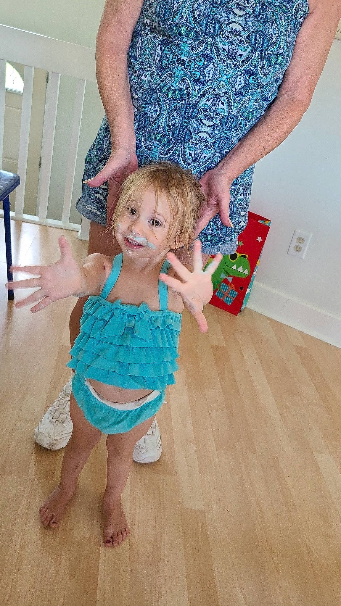 Eleanor joined the competition — help win amazing prizes! arm, baby_toddler_clothing, blue, child, dress, floor, flooring, gesture, hair, hand, happy, joint, joy, leg, person, smile, standing, thigh, thumb, toddler